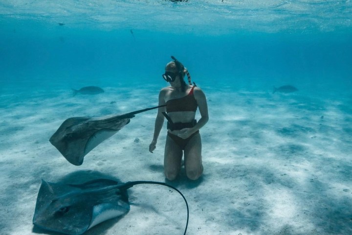 a man that is standing in the water